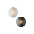 Matte white and smoke-grey Clérachic ribbed pendants shown together on a white backdrop, both lit warmly.