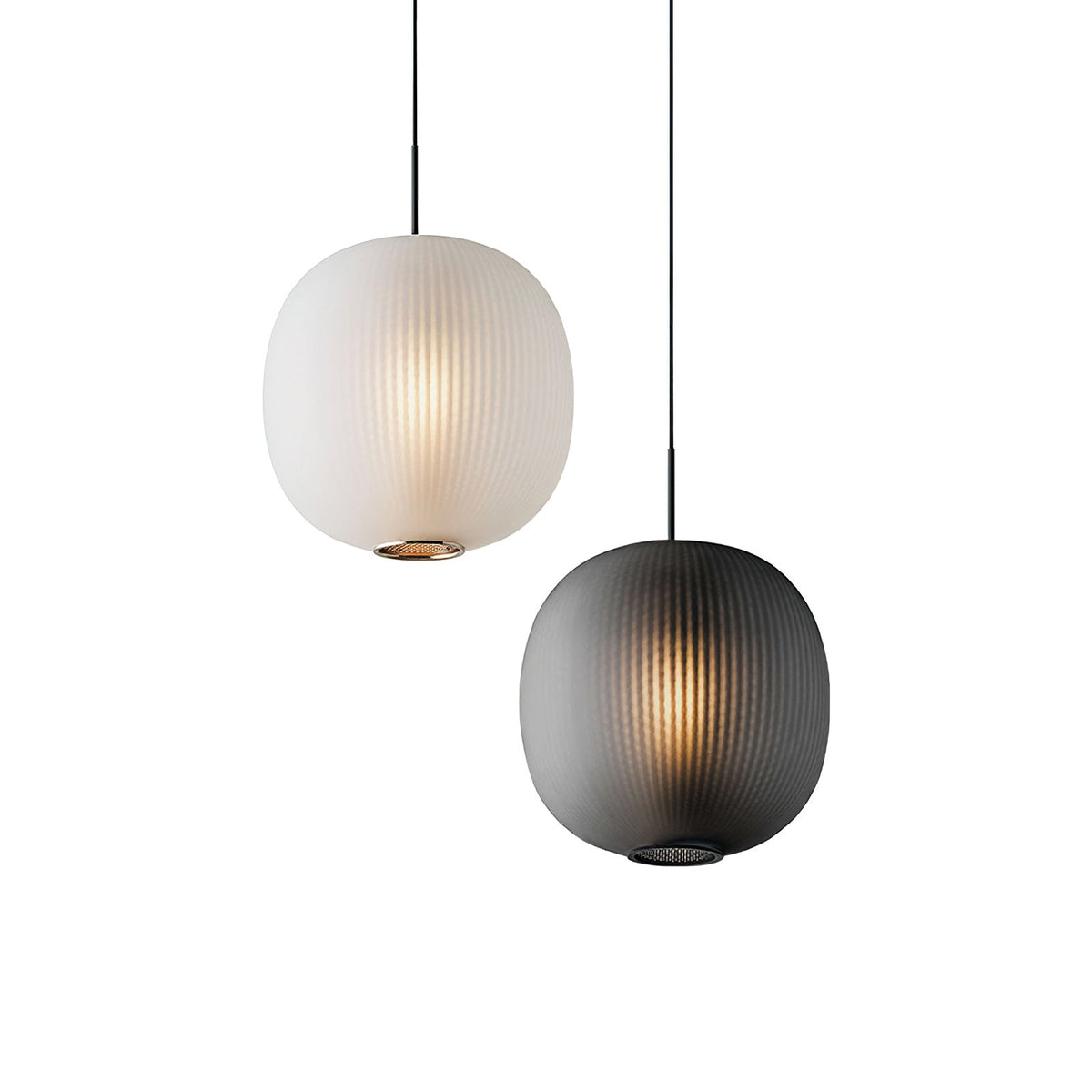 Matte white and smoke-grey Clérachic ribbed pendants shown together on a white backdrop, both lit warmly.