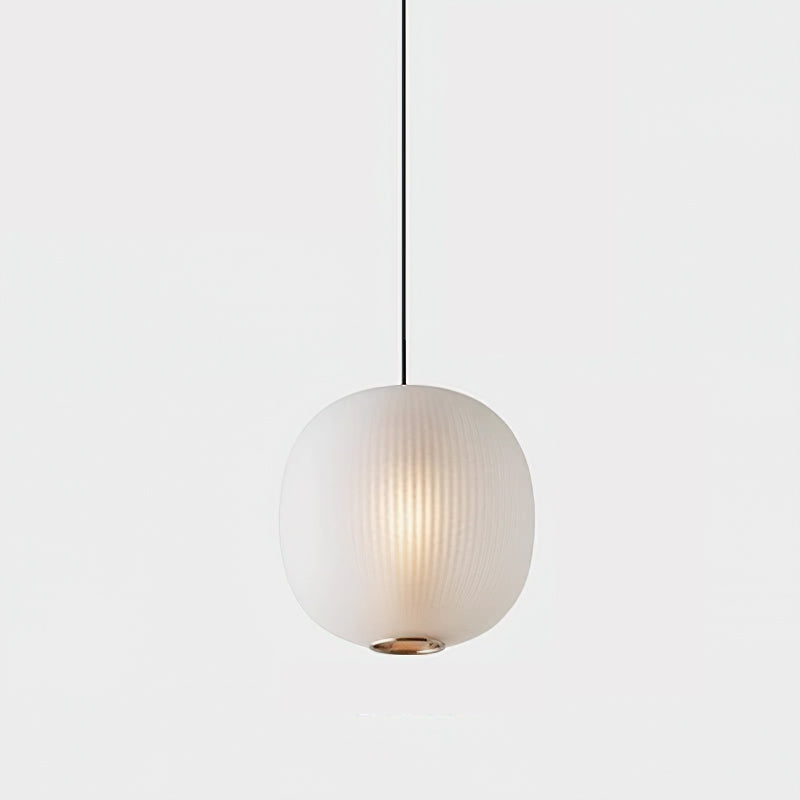 Single matte white Clérachic pendant on a pale backdrop, its ribbed glass softly glowing above a small brass-toned ring.
