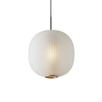Front view of a matte white Clérachic ribbed glass pendant, with the vertical ribbing and a perforated base ring visible.