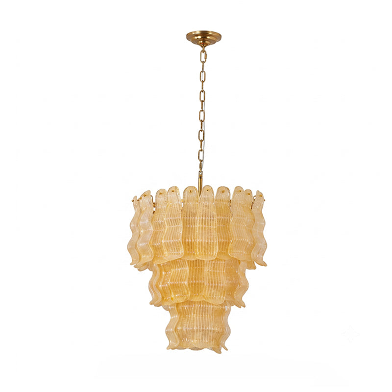 Yellow Clérachic pendant on white, shown with its warm amber glass tiers and a long brass chain above.