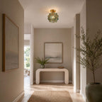 Teal glass-petal Clérachic ceiling light in a hallway with a curved white console, an olive tree and a seascape print.
