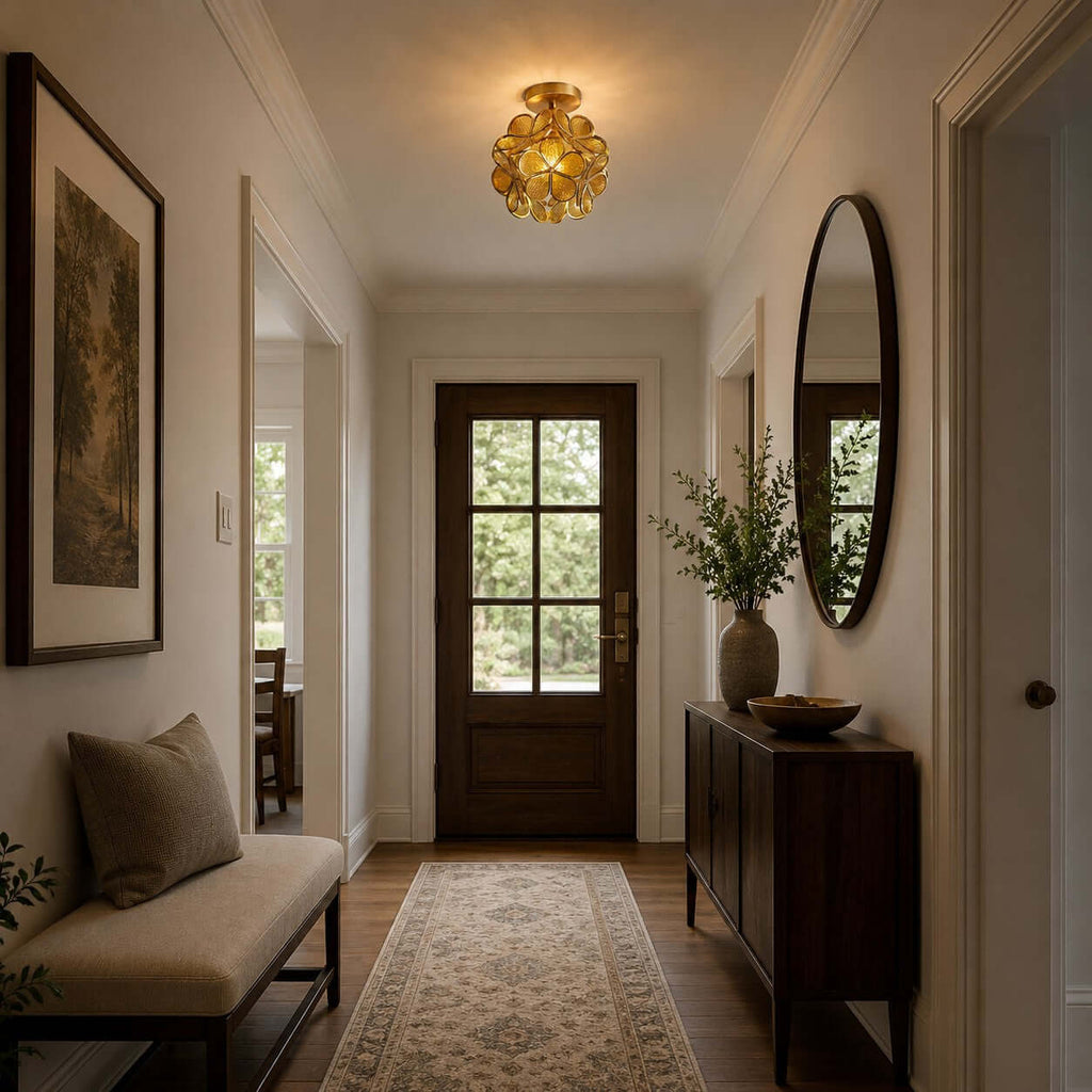 Clear-petal Clérachic ceiling light in a hallway with a dark wood front door, an oval mirror and a patterned runner.