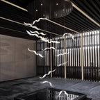 White glass gulls of this Clérachic chandelier hang on thin cables in a dark hall with slatted screens and a reflecting pool.