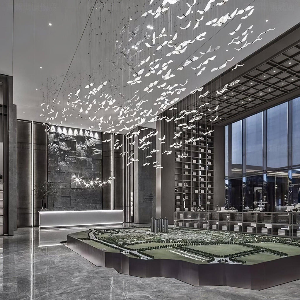 This Clérachic seagull chandelier fills a double-height lobby with hundreds of glass birds above a polished stone floor.