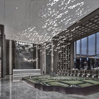 This Clérachic seagull chandelier fills a double-height lobby with hundreds of glass birds above a polished stone floor.