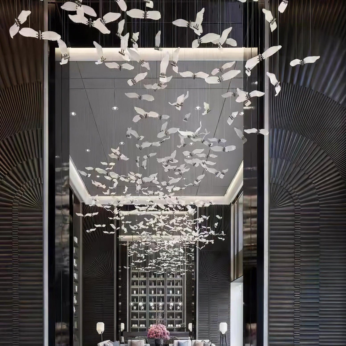 Looking up a dark panelled atrium, this Clérachic seagull chandelier scatters glass birds from floor to ceiling.