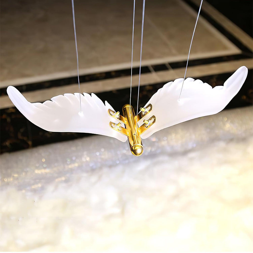 Close view of a single frosted glass seagull on this Clérachic chandelier, with its gold body and cable fixings.