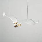 Close view of one frosted glass seagull on this Clérachic chandelier, with its brass body, screws and two thin cables.