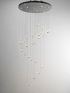 This Clérachic seagull chandelier hangs from a large dark canopy, its glass gulls glowing in a long spiral.