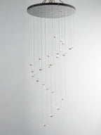 Unlit glass gulls spiral down on fine cables from the dark canopy of this Clérachic seagull chandelier.