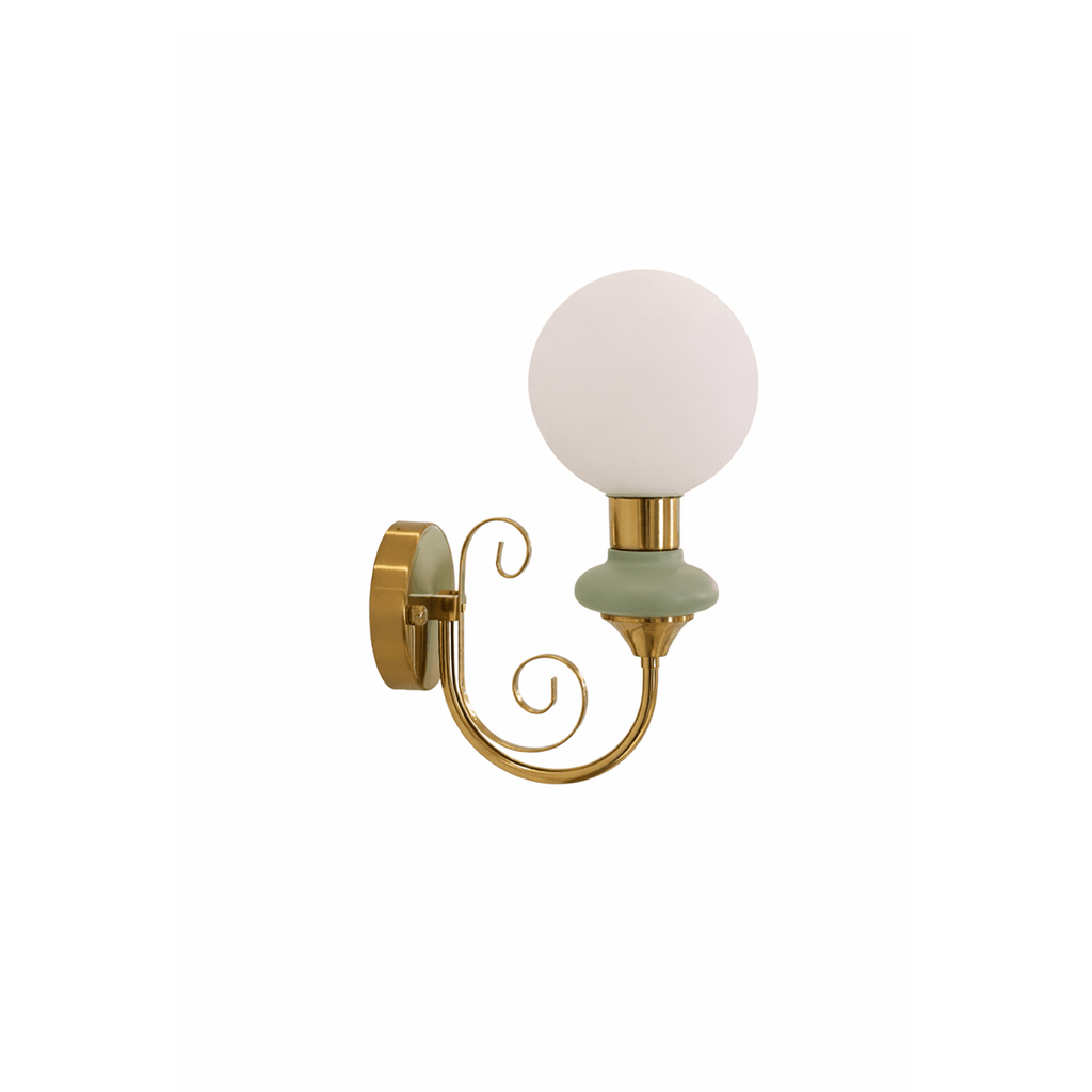 A Clérachic wall light with a pale green collar, an unlit white globe and a gold scrolled arm, on a plain white background.