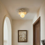 Clérachic resin-collar ceiling light lit in a small hallway, with an arched opening, a dark wood door and a framed floral print.