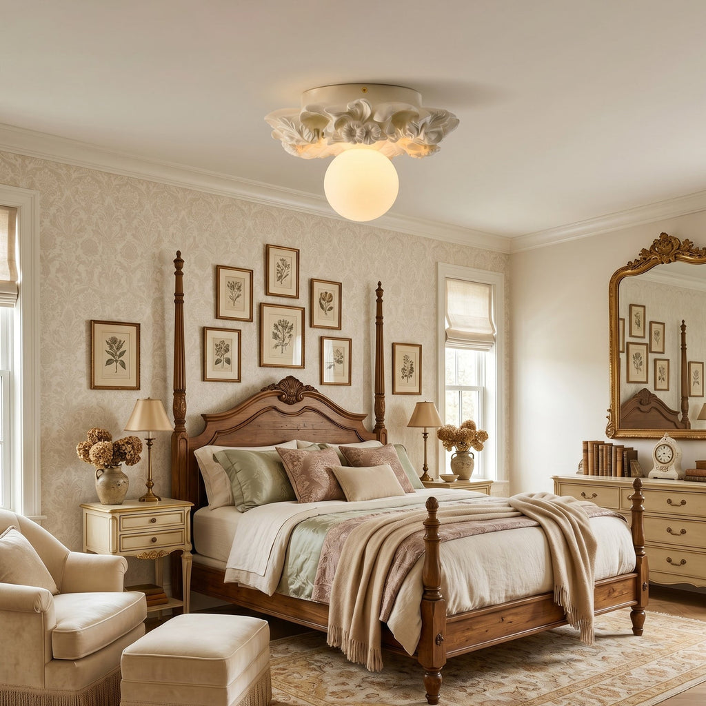 Ivory Clérachic ceiling light above a four-poster bedroom with patterned wallpaper, two bedside lamps and a gilt mirror.