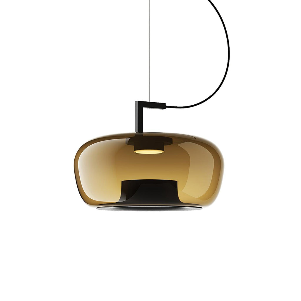 Wide amber glass Clérachic pendant with a black bracket and a warm light at its centre, on a white backdrop.