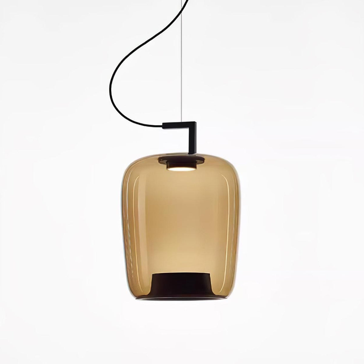 Tall amber glass Clérachic pendant with a black bracket and a glowing top, shown on a white backdrop.
