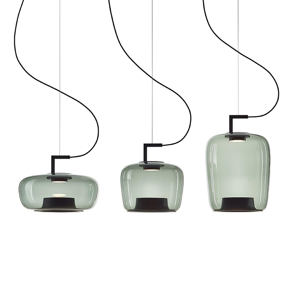 Three grey-green glass Clérachic pendants in wide, squat and tall shapes hang at different heights on a white backdrop.