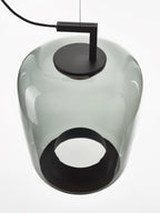 Close view from below of a grey-green glass Clérachic pendant, with its black cap on top and a round black opening.
