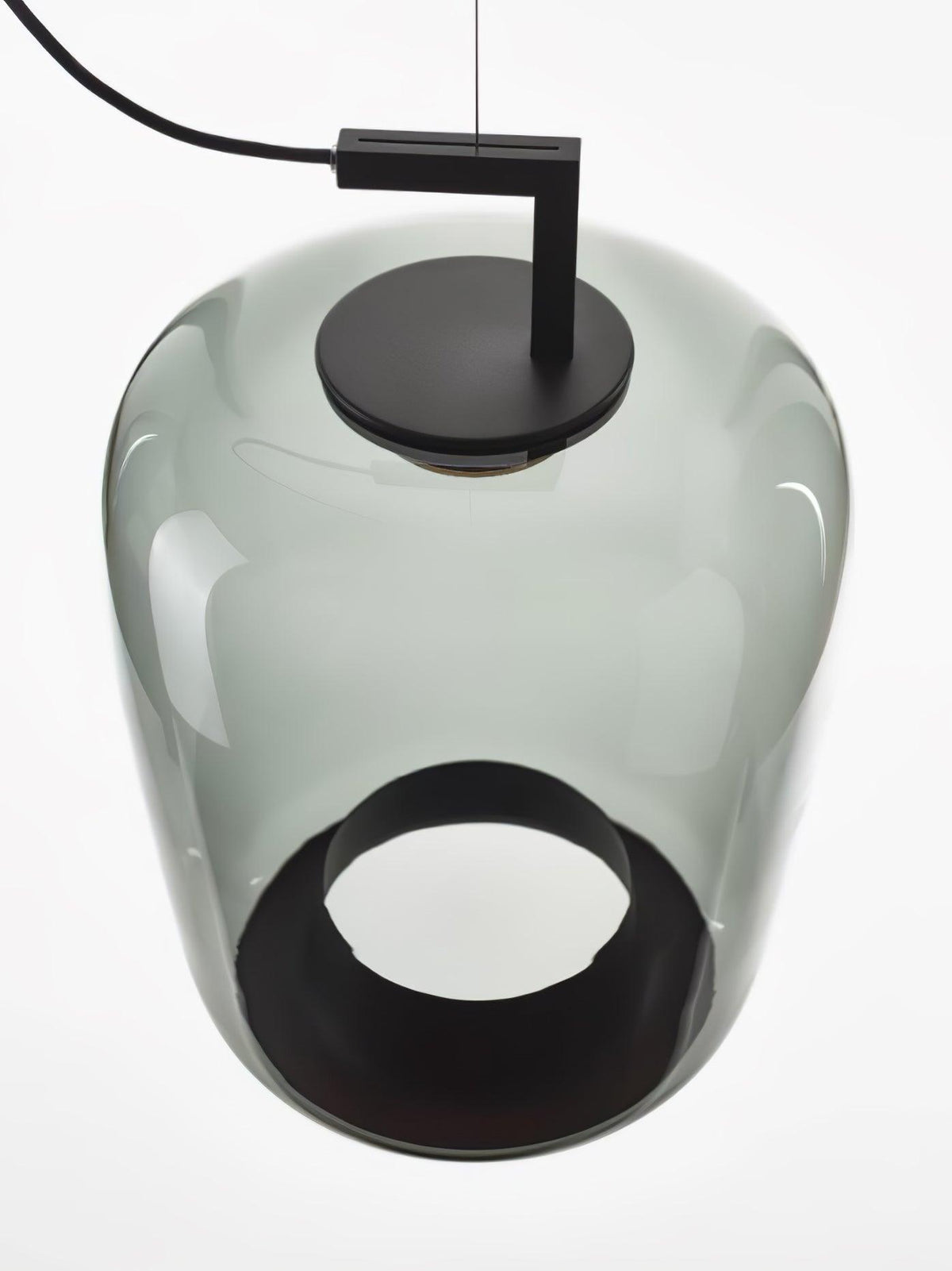 Close view from below of a grey-green glass Clérachic pendant, with its black cap on top and a round black opening.