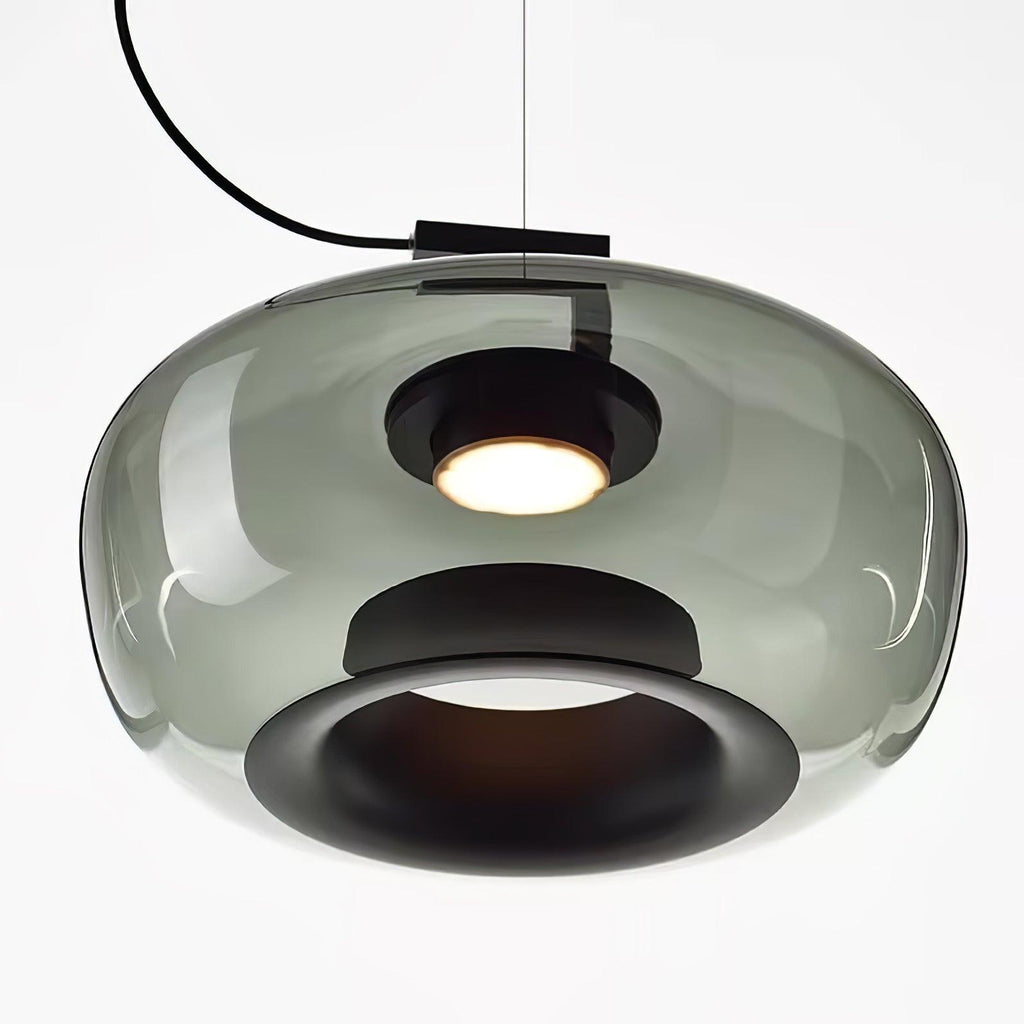 Close view from below of a wide grey glass Clérachic pendant, with its black inner ring and a glowing light.