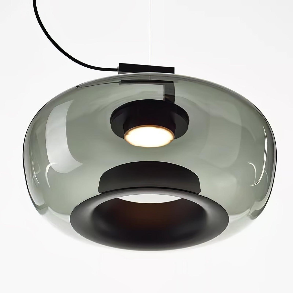 Close view from below of a wide grey glass Clérachic pendant, with its black inner ring and a glowing light.