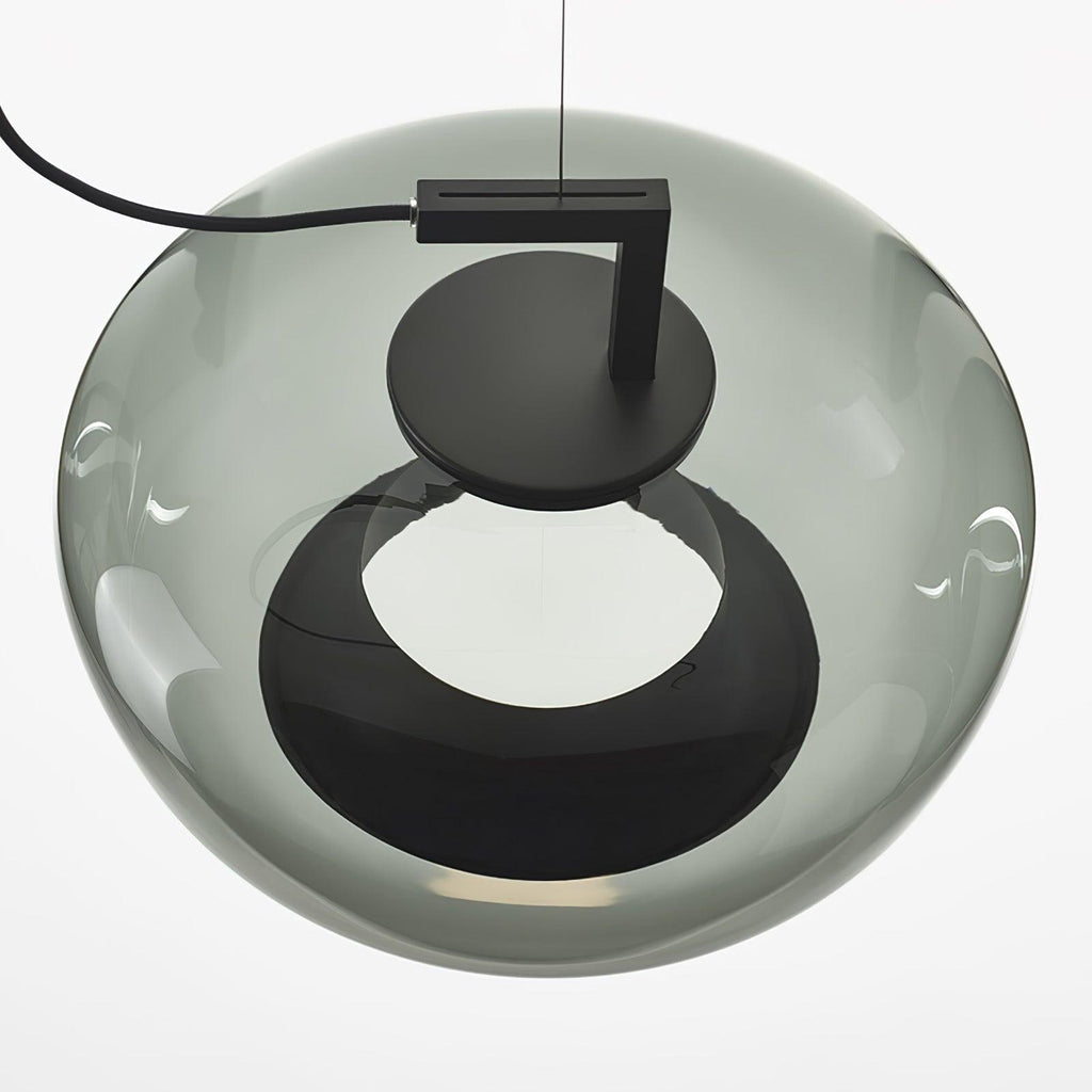 Close view from below of a rounded grey glass Clérachic pendant, with its black disc cap and a dark ring opening.