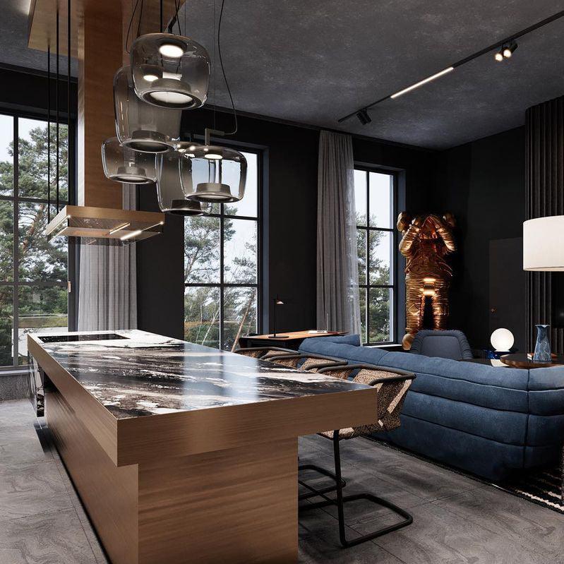Smoke grey Clérachic pendants hang above a marble-topped wooden kitchen island, with a blue sofa in the room behind.