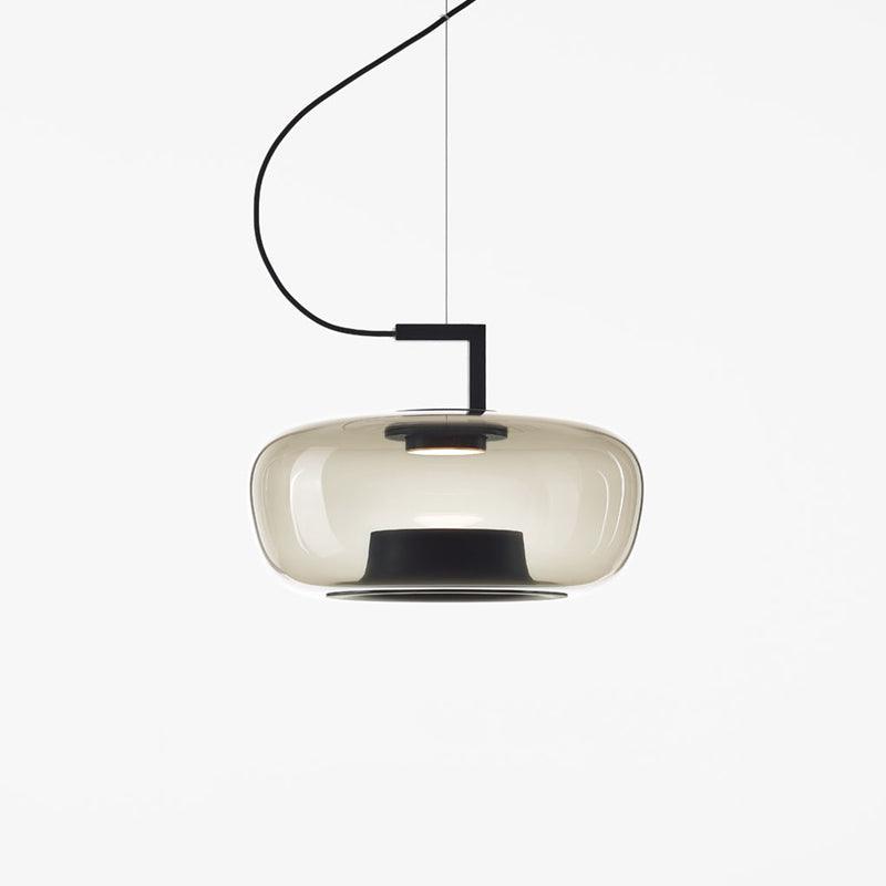 Wide foggy white glass Clérachic pendant with a soft glow and a black base ring, on a white backdrop.