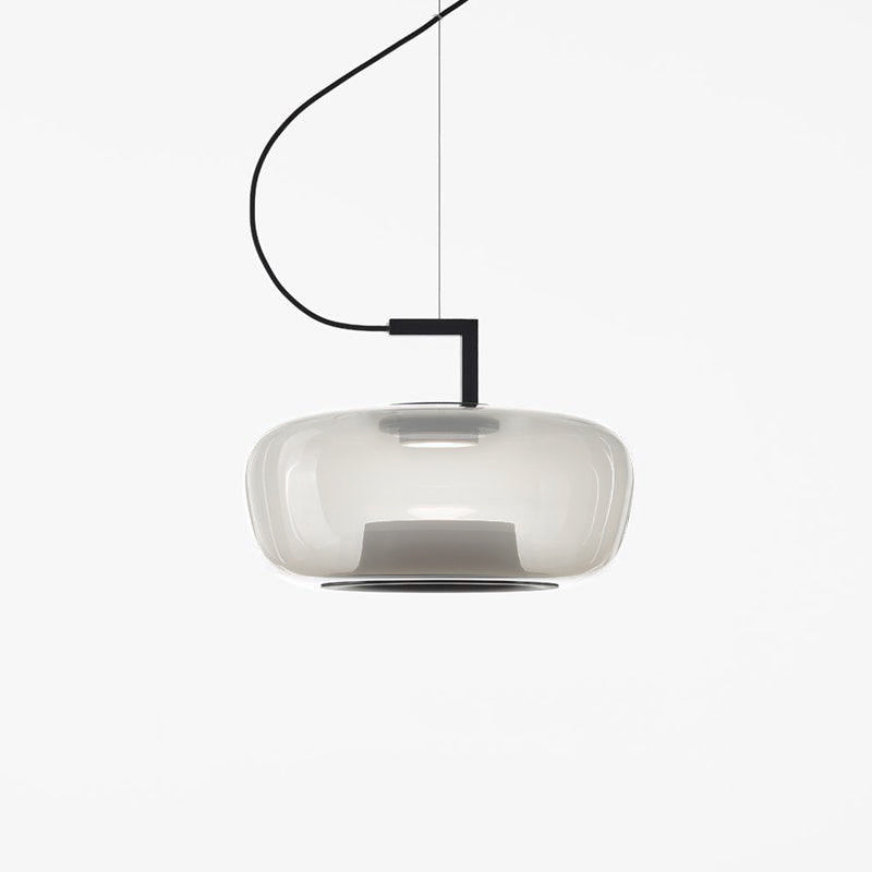 Wide pale grey glass Clérachic pendant with a soft glow and a black bracket on a plain white backdrop.