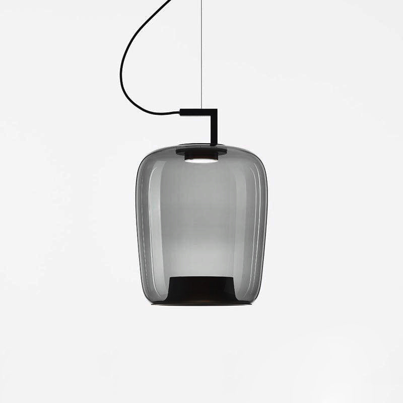 Tall smoke grey glass Clérachic pendant with a black bracket and a darker base, on a light grey backdrop.