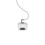 Small squat clear glass Clérachic pendant with a black bracket and a light base ring, on a white backdrop.