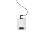Small tall clear glass Clérachic pendant with a black bracket and a dark base, on a white backdrop.
