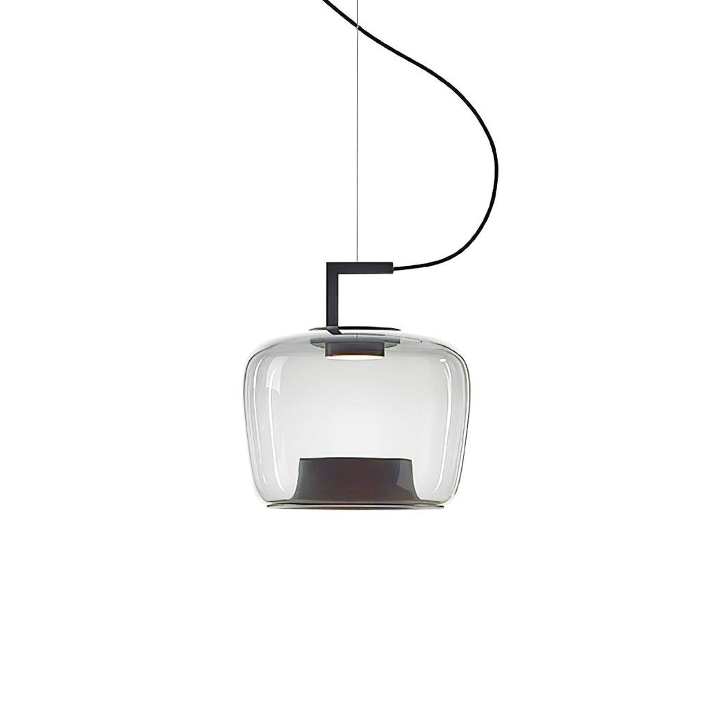 Squat clear glass Clérachic pendant with a black bracket and a dark base, hanging on a curved cord on white.