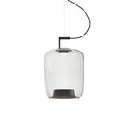 Tall clear glass Clérachic pendant with a black bracket and a dark inner base, on a white backdrop.