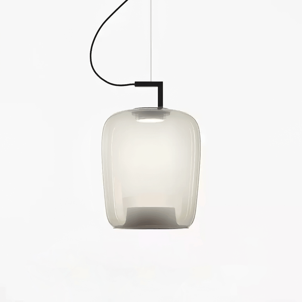 Tall foggy white glass Clérachic pendant with a black bracket and a soft glow, on a plain white backdrop.
