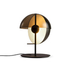 Black Clérachic table lamp with a smoked half-dome shade and a pale half-sphere, seen at a slight angle on white.