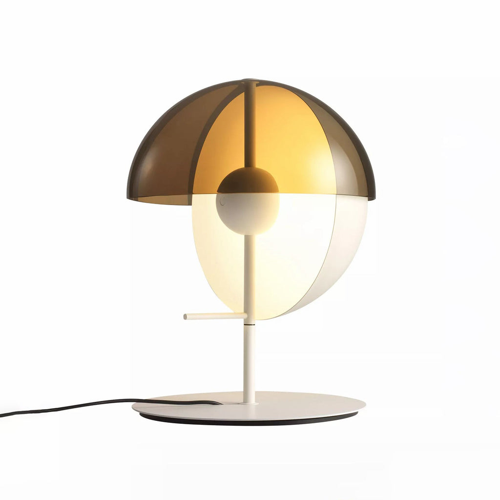 Straight-on view of a white-based Clérachic table lamp with a smoked-amber half-dome over a pale half-sphere on white.