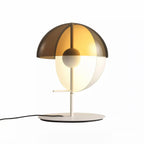 Straight-on view of a white-based Clérachic table lamp with a smoked-amber half-dome over a pale half-sphere on white.