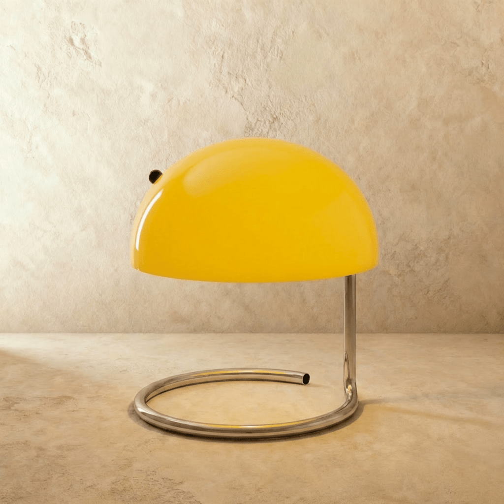 A closer view of the Clérachic yellow glass dome lamp shows its glossy chrome swirl-base stand.