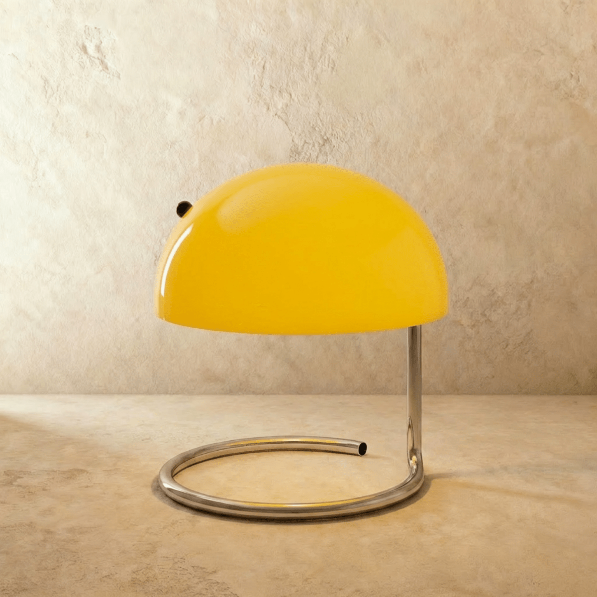 A closer view of the Clérachic yellow glass dome lamp shows its glossy chrome swirl-base stand.