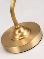 Close view of the stepped round base and the reeded brass arm where it meets the base on this Clérachic lamp.