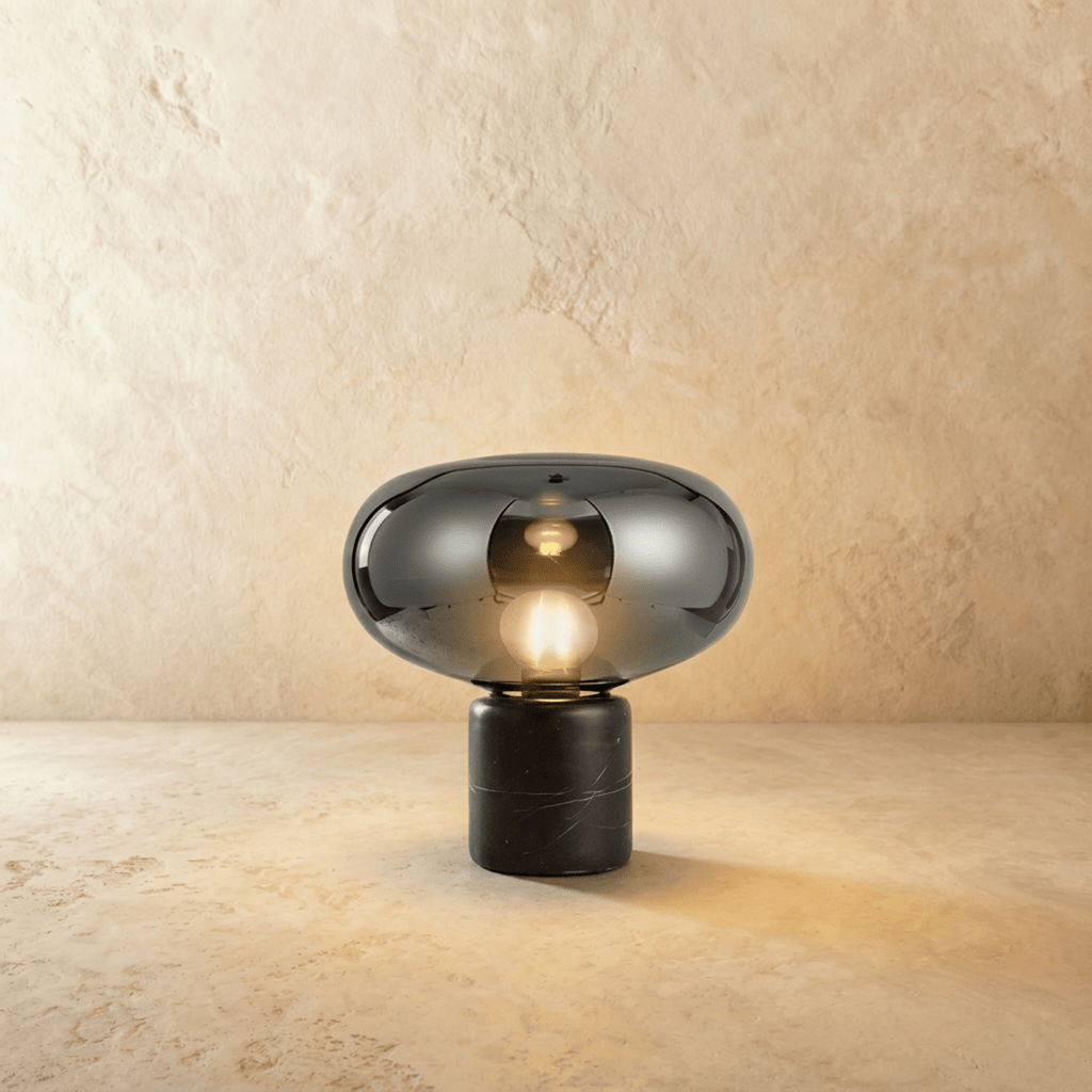 Clérachic table lamp with a mirrored smoky grey glass shade and an opal bulb above a black marble base