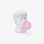 A Clérachic white bust lamp with a pink bubble, seen at a slight angle on a plain white backdrop with a soft shadow below.