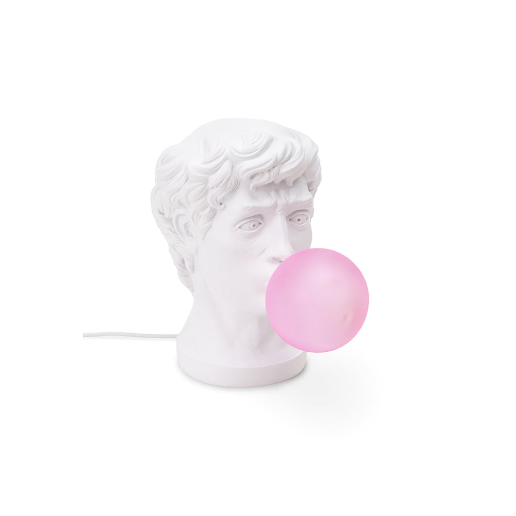 A Clérachic white bust lamp with a pale pink bubble and white cord, seen from the front on a plain white backdrop.