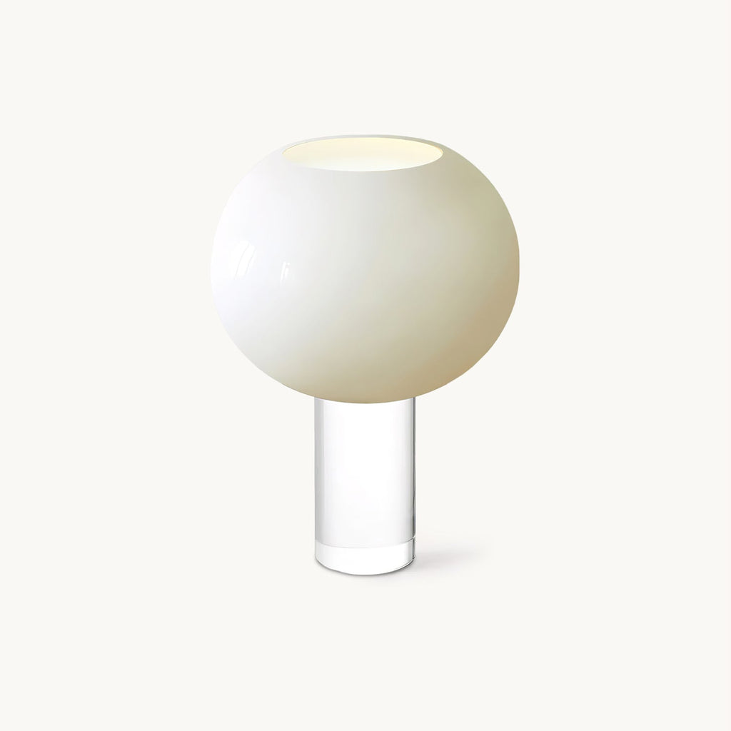 A white spherical glass diffuser with an open top sits on a clear glass cylinder, this Clérachic table lamp shown on a plain backdrop.
