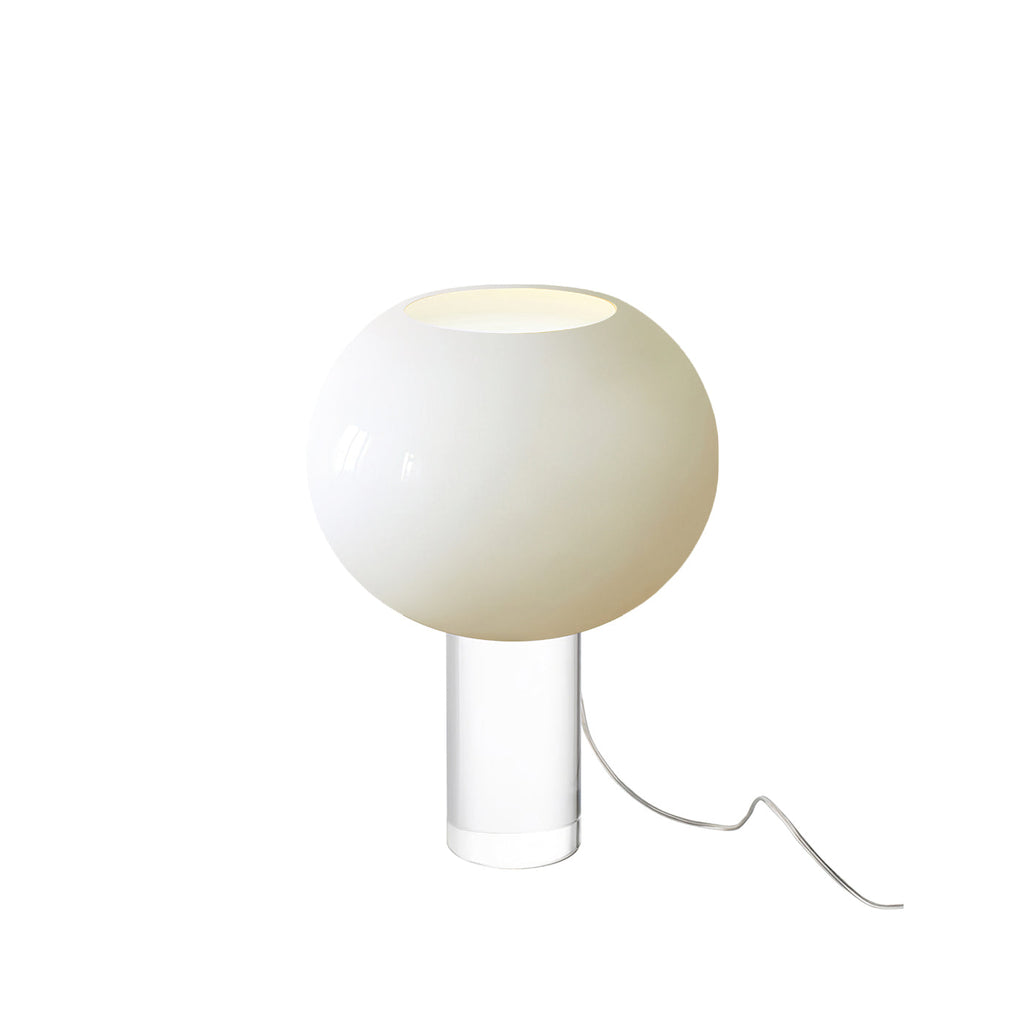 This Clérachic table lamp in white, a glossy glass globe on a clear cylindrical base, on a white backdrop with a clear cord.