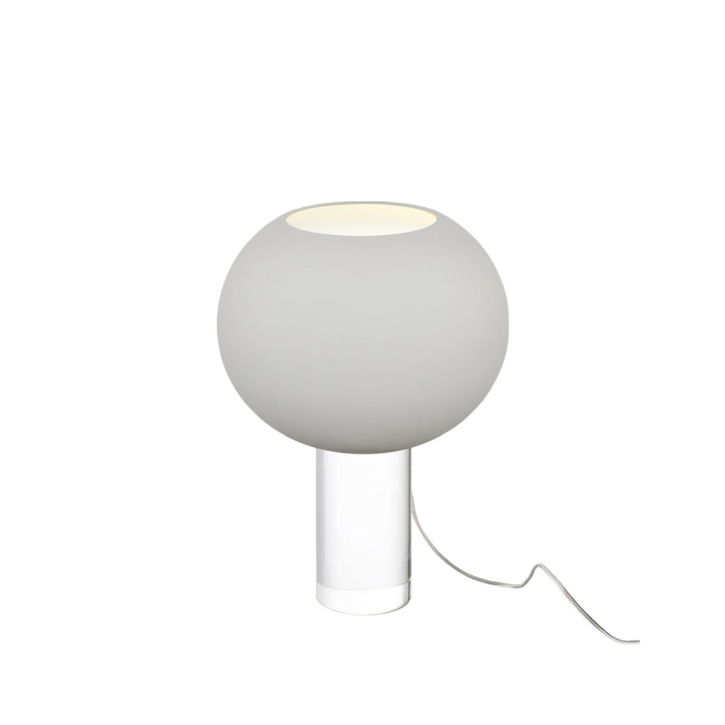 A smaller grey Clérachic table lamp, its frosted globe on a short clear base, with a clear cord looping to the right.