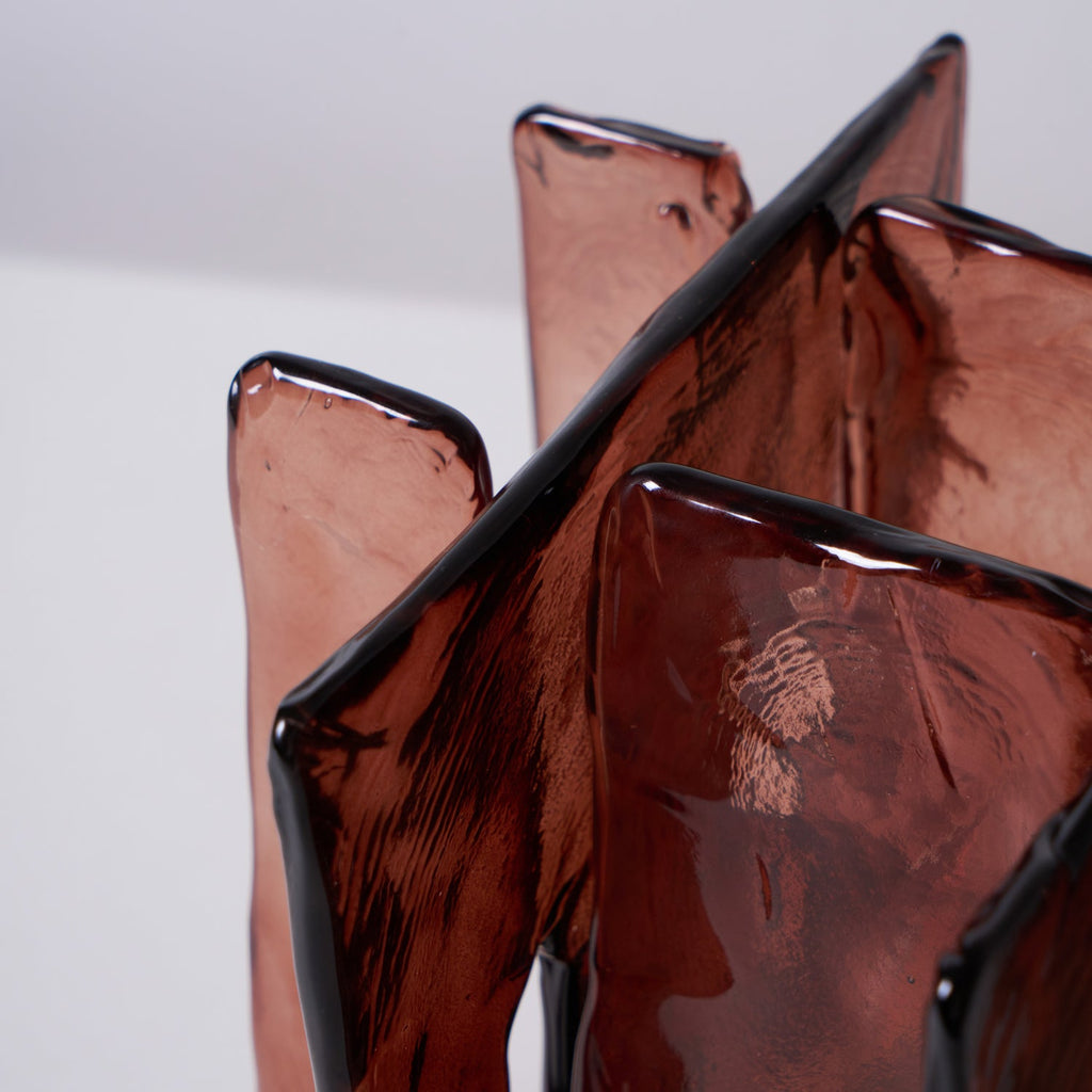 Close view of the rippled amber-red glass panels on this Clérachic table lamp, edged with a thin dark rim where the pieces meet.