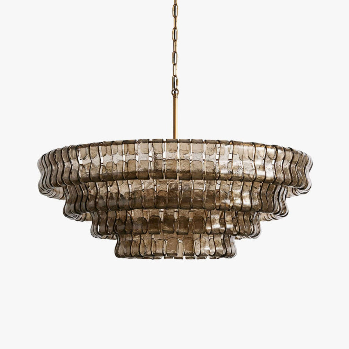 Smoke-grey glass tiles in stepped rings on this Clérachic chandelier, hung from a brass chain against a plain white backdrop.