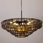 Seen from below, this smoke-grey Clérachic chandelier shows a black spoke frame and exposed warm bulbs inside the glass rim.
